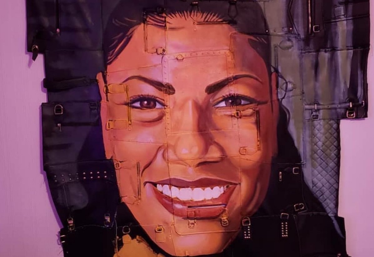 Painting of a woman smiling on a leather canvas